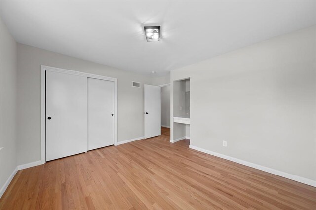 1865 Shardell Dr, Spanish Lake Township, MO 63138 - unfurnished bedroom featuring baseboards, light wood-type flooring, and a closet