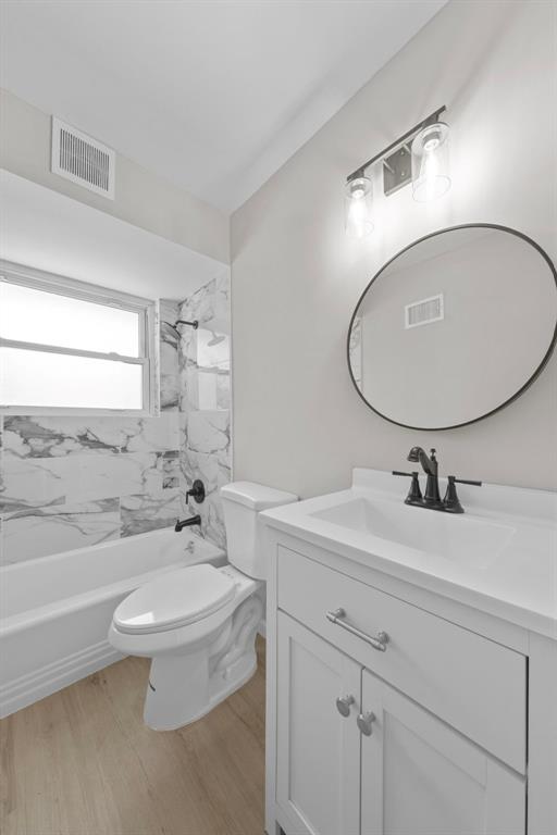 1865 Shardell Dr, Spanish Lake Township, MO 63138 - full bathroom with vanity, wood finished floors,  shower combination, and toilet