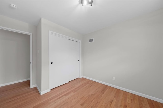 1865 Shardell Dr, Spanish Lake Township, MO 63138 - unfurnished bedroom featuring light wood-type flooring, baseboards, and a closet