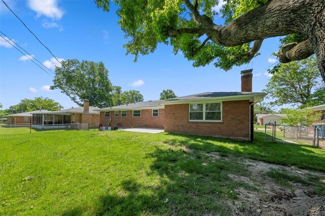 1865 Shardell Dr, Spanish Lake Township, MO 63138 - back of house featuring a chimney, brick siding, and a patio