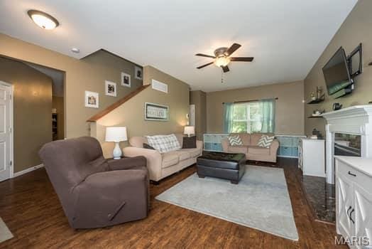 538 Springhurst Pkwy, Ofallon, MO 63368 - living room featuring ceiling fan and dark wood-type flooring