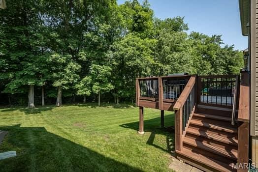 538 Springhurst Pkwy, Ofallon, MO 63368 - view of green lawn with a wooden deck and stairs