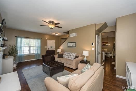 538 Springhurst Pkwy, Ofallon, MO 63368 - living room with ceiling fan, dark wood finished floors, and baseboards