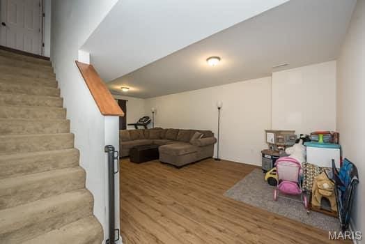 538 Springhurst Pkwy, Ofallon, MO 63368 - living room with wood finished floors and stairs