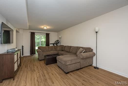 538 Springhurst Pkwy, Ofallon, MO 63368 - living area featuring light wood finished floors and baseboards