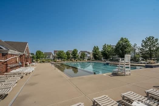538 Springhurst Pkwy, Ofallon, MO 63368 - community pool featuring a patio area