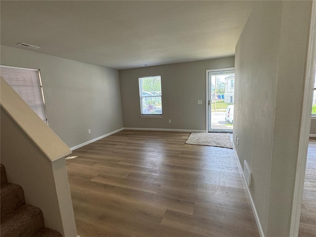 3624 Market St, Saint Louis, MO 63115 - foyer entrance with wood finished floors, stairs, and baseboards