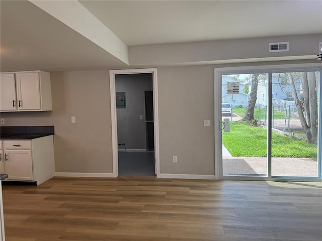 3624 Market St, Saint Louis, MO 63115 - unfurnished dining area with baseboards and wood finished floors