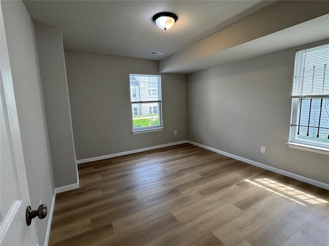 3624 Market St, Saint Louis, MO 63115 - spare room with baseboards and wood finished floors