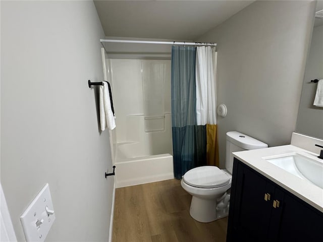 3624 Market St, Saint Louis, MO 63115 - full bathroom with wood finished floors, toilet, vanity, and shower / bath combo with shower curtain
