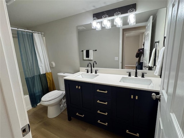 3624 Market St, Saint Louis, MO 63115 - full bath featuring toilet, double vanity, wood finished floors, and shower / bathtub combination with curtain