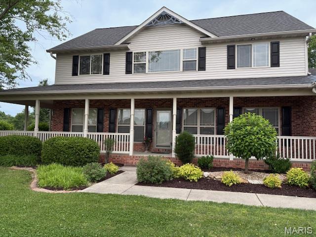 6517 Augies Way Pl, Millstadt, IL 62260 - view of front facade featuring a porch, brick siding, and a front lawn