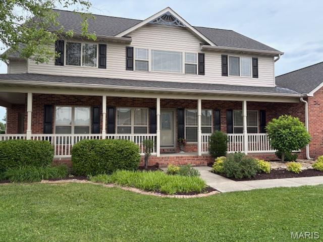 6517 Augies Way Pl, Millstadt, IL 62260 - view of front of home with covered porch, brick siding, a front lawn, and a shingled roof
