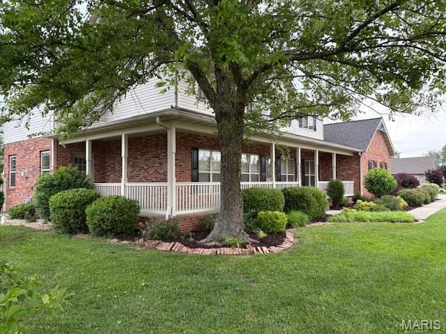 6517 Augies Way Pl, Millstadt, IL 62260 - view of front of house with brick siding, a front lawn, and a porch