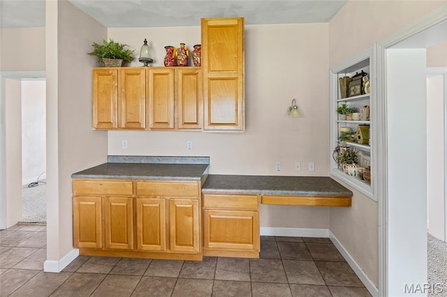 6517 Augies Way Pl, Millstadt, IL 62260 - kitchen featuring dark countertops, built in study area, and dark tile patterned flooring