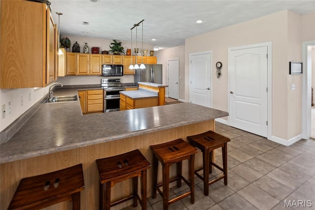 6517 Augies Way Pl, Millstadt, IL 62260 - kitchen featuring appliances with stainless steel finishes, a peninsula, recessed lighting, a breakfast bar, and light tile patterned floors