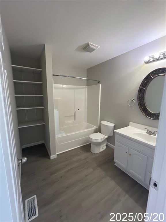 14 Mandy Ct, Troy, MO 63379 - full bathroom with vanity, baseboards, bathing tub / shower combination, toilet, and wood finished floors