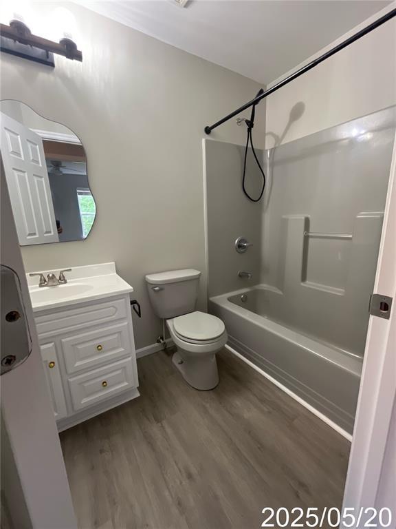 14 Mandy Ct, Troy, MO 63379 - full bathroom with toilet, washtub / shower combination, vanity, and wood finished floors