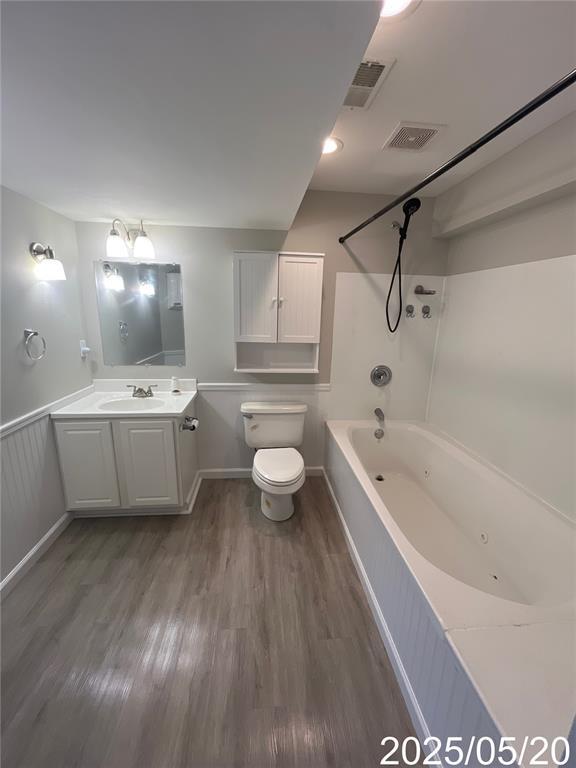 14 Mandy Ct, Troy, MO 63379 - bathroom with wood finished floors, vanity, toilet, and a combined bath / shower with jetted tub