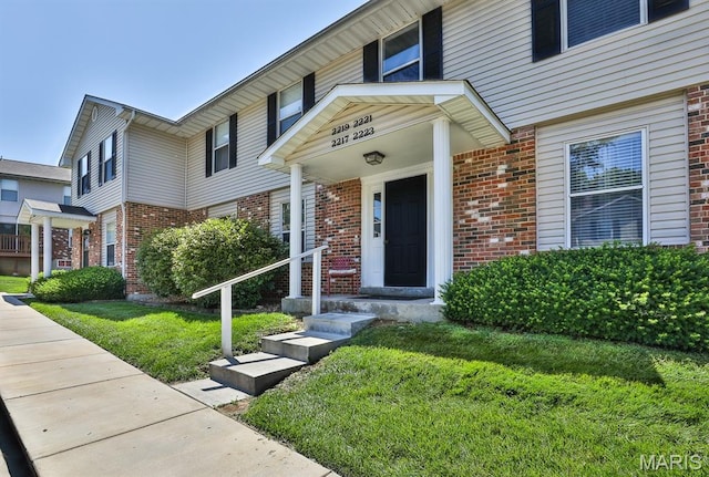 2223 Highland Hill Drive E, Saint Peters, MO 63376 - doorway to property featuring brick siding and a lawn