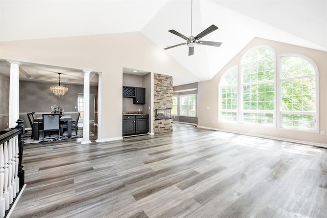 3 Wedgewood Ct, Edwardsville, IL 62025 - living area featuring ornate columns, a ceiling fan, a chandelier, light wood finished floors, and baseboards