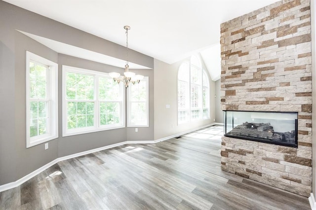3 Wedgewood Ct, Edwardsville, IL 62025 - unfurnished living room featuring lofted ceiling, a chandelier, plenty of natural light, and wood finished floors