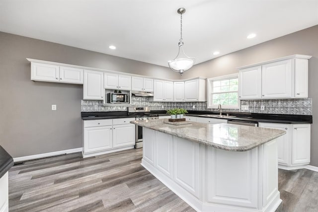 3 Wedgewood Ct, Edwardsville, IL 62025 - kitchen featuring gas stove, built in microwave, white cabinetry, and recessed lighting