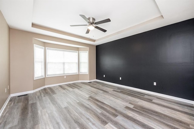 3 Wedgewood Ct, Edwardsville, IL 62025 - spare room featuring a raised ceiling, ceiling fan, wood finished floors, and baseboards