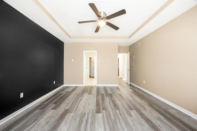 3 Wedgewood Ct, Edwardsville, IL 62025 - unfurnished room featuring a raised ceiling, a ceiling fan, wood finished floors, and baseboards