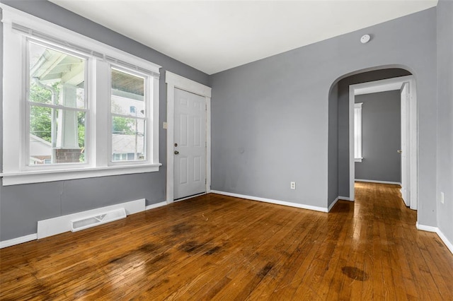 7348 Grand Dr, Pagedale, MO 63133 - foyer with arched walkways, wood-type flooring, and baseboards