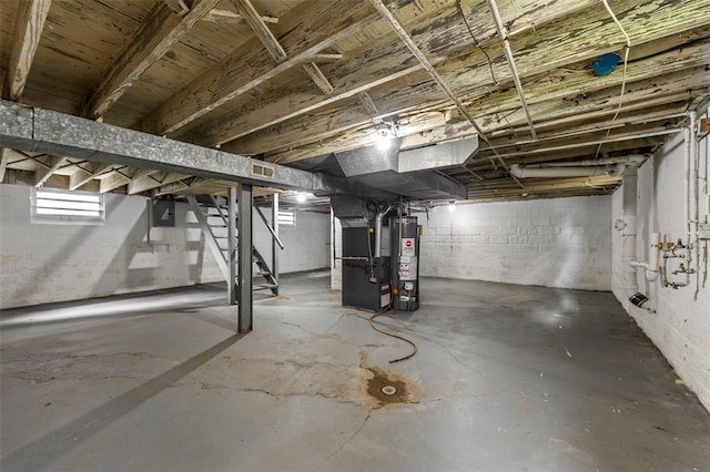 7348 Grand Dr, Pagedale, MO 63133 - below grade area featuring heating unit, stairs, and gas water heater
