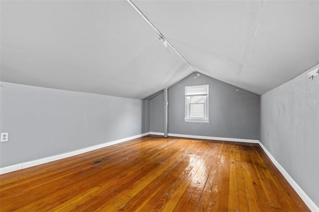 7348 Grand Dr, Pagedale, MO 63133 - additional living space with vaulted ceiling, hardwood / wood-style floors, and baseboards