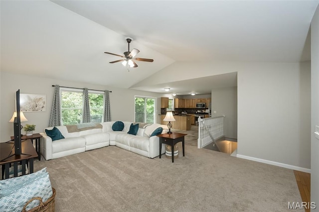 3414 Bedford Falls Dr, Wentzville, MO 63385 - carpeted living room featuring ceiling fan, lofted ceiling, and baseboards