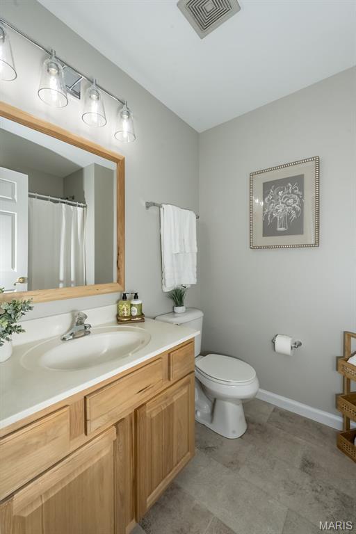 3414 Bedford Falls Dr, Wentzville, MO 63385 - bathroom with toilet, vanity, and baseboards