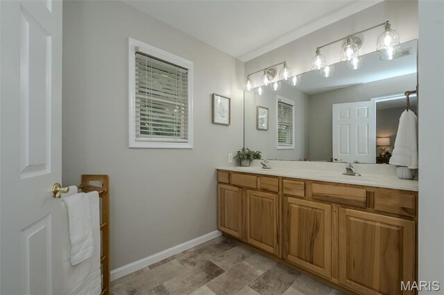 3414 Bedford Falls Dr, Wentzville, MO 63385 - full bath featuring double vanity, baseboards, and stone finish flooring