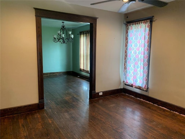 201 3rd St, Chaffee, MO 63740 - spare room featuring wood finished floors, ceiling fan, a chandelier, and baseboards