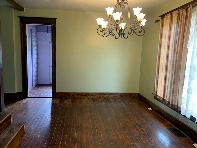 201 3rd St, Chaffee, MO 63740 - empty room featuring hardwood / wood-style floors, a chandelier, and baseboards