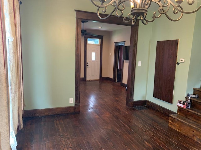 201 3rd St, Chaffee, MO 63740 - unfurnished dining area with a chandelier, hardwood / wood-style flooring, and baseboards