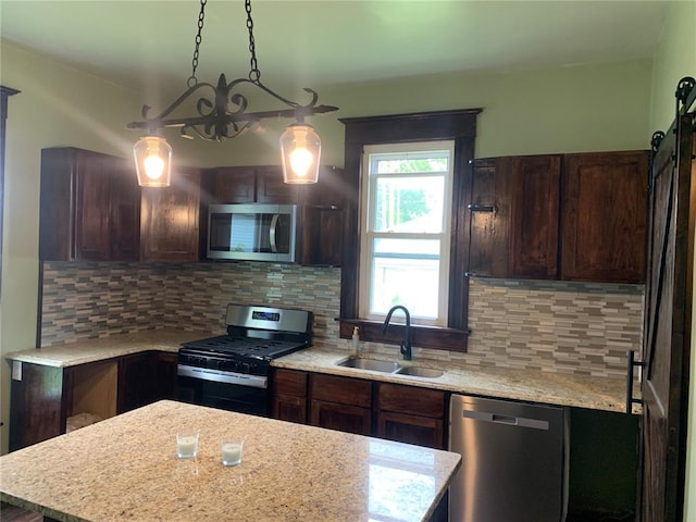 201 3rd St, Chaffee, MO 63740 - kitchen featuring appliances with stainless steel finishes, a sink, dark brown cabinets, and tasteful backsplash