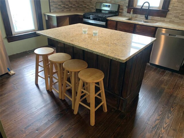 201 3rd St, Chaffee, MO 63740 - kitchen with stainless steel appliances, a sink, dark wood-style floors, and plenty of natural light