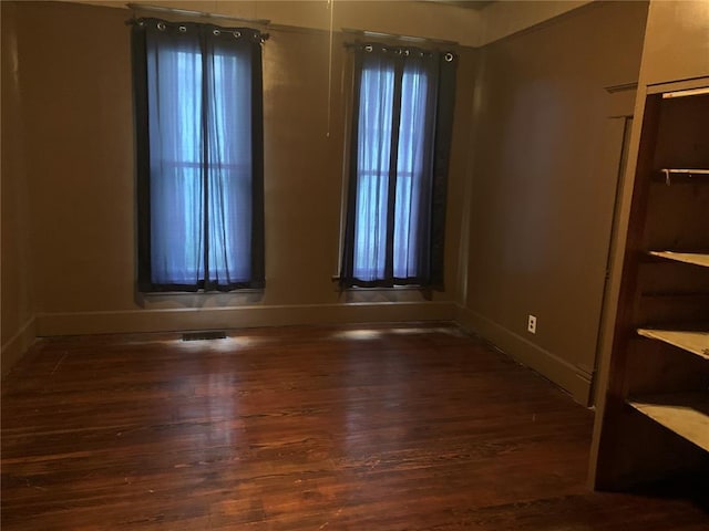 201 3rd St, Chaffee, MO 63740 - unfurnished room featuring baseboards, wood finished floors, and healthy amount of natural light