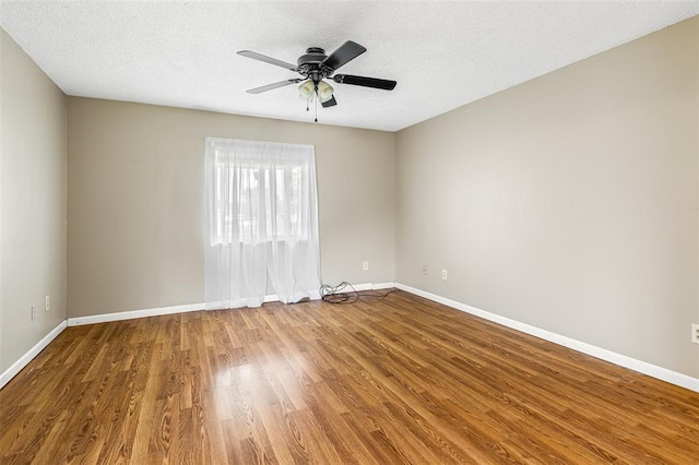 1111 Bluffview Dr, Desloge, MO 63628 - unfurnished room with wood finished floors, baseboards, ceiling fan, and a textured ceiling