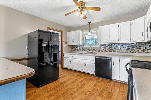 1111 Bluffview Dr, Desloge, MO 63628 - kitchen featuring black appliances, a sink, ceiling fan, light wood-style flooring, and white cabinetry