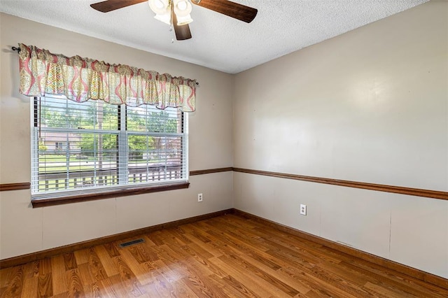 1111 Bluffview Dr, Desloge, MO 63628 - unfurnished room featuring plenty of natural light, ceiling fan, wood finished floors, and a textured ceiling