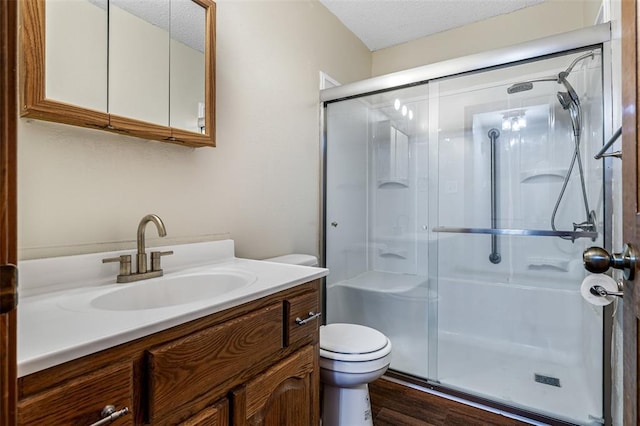 1111 Bluffview Dr, Desloge, MO 63628 - full bath featuring toilet, a stall shower, vanity, wood finished floors, and a textured ceiling