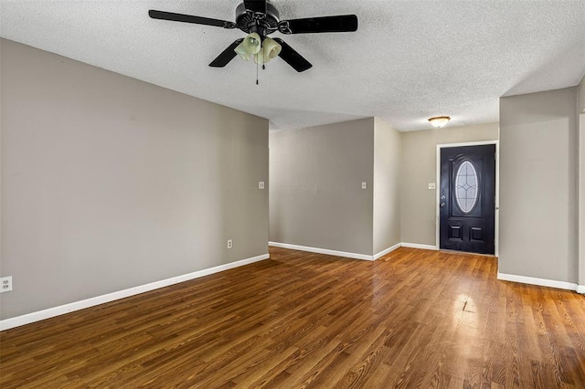 1111 Bluffview Dr, Desloge, MO 63628 - entryway featuring a textured ceiling, baseboards, wood finished floors, and a ceiling fan