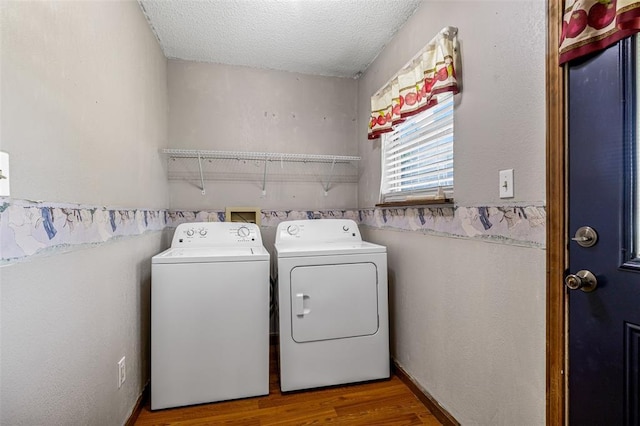 1111 Bluffview Dr, Desloge, MO 63628 - washroom featuring washing machine and clothes dryer, wood finished floors, and a textured ceiling