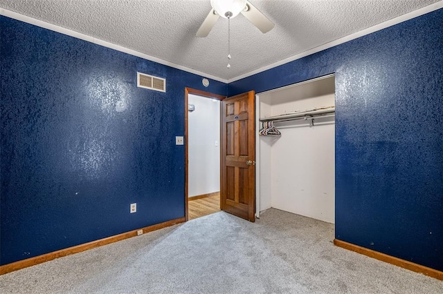 1111 Bluffview Dr, Desloge, MO 63628 - unfurnished bedroom featuring carpet floors, a textured ceiling, a closet, a ceiling fan, and a textured wall