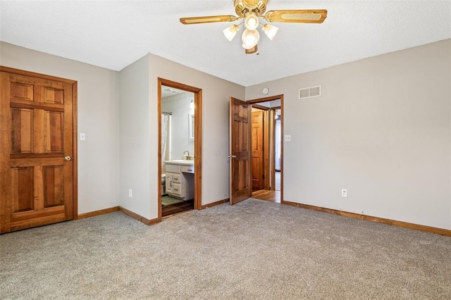 1111 Bluffview Dr, Desloge, MO 63628 - unfurnished bedroom with baseboards, light carpet, a sink, a ceiling fan, and ensuite bathroom