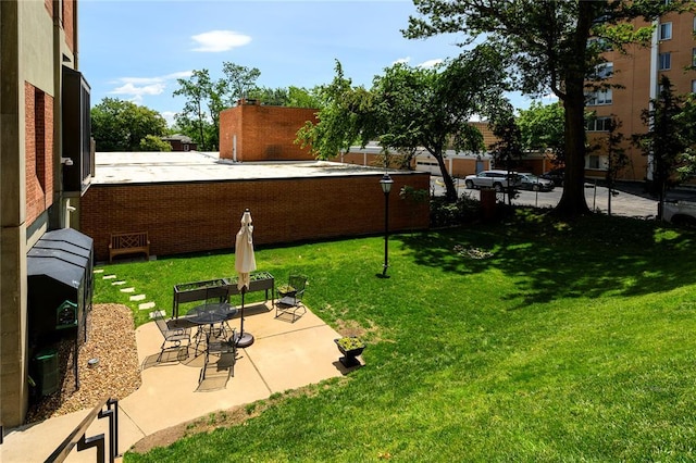 816 S Hanley Rd Unit 8C, Saint Louis, MO 63105 - view of grassy yard with a patio